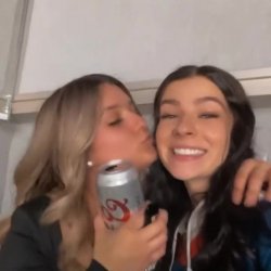 Sexy sisters teasing with a kiss on cheek